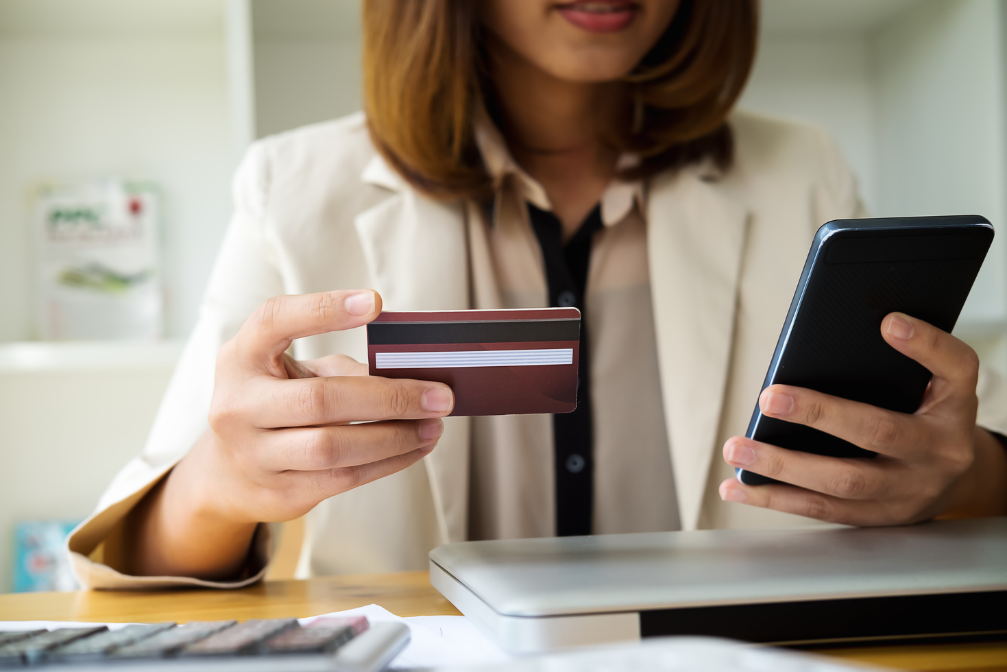 Woman Hands Holding Credit Card and Using Phone